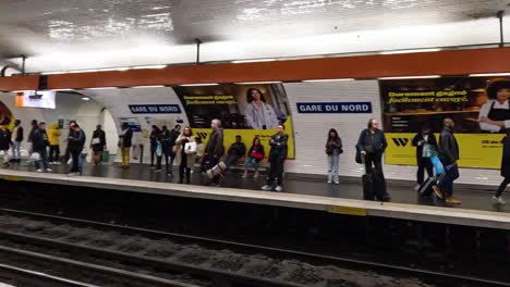 passengers waiting and moving in a subway station