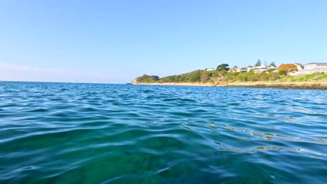 Gentle ocean waves under clear skies, capturing the tranquil beauty of Mornington Peninsula's coastline