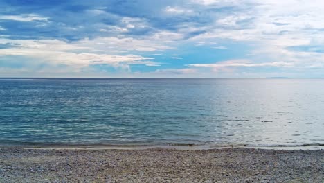 Calm-and-sunny-day-over-a-tropical-pebble-beach