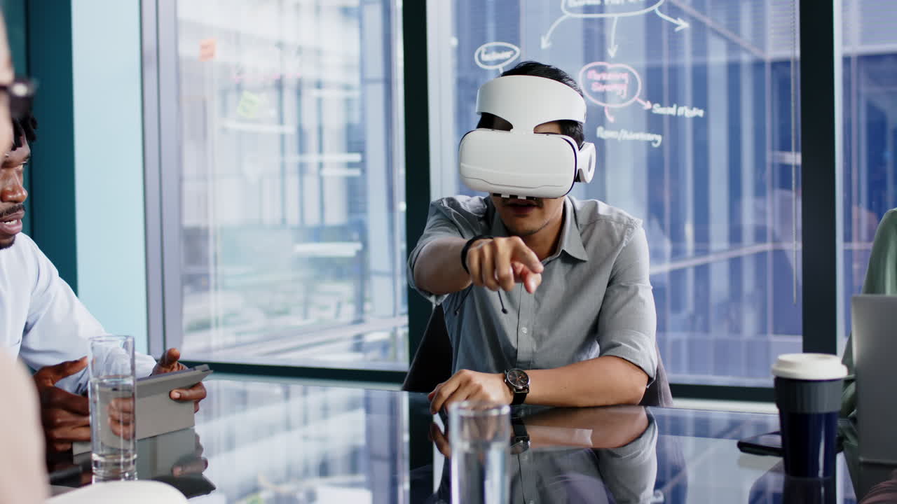Using VR headset, man pointing and interacting in modern office meeting