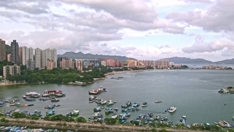 Aerial-view-of-the-typhoon-shelter-with-boats-and-vessels-and-many-residential-buildings-on-the-2-sides-of-the-sea