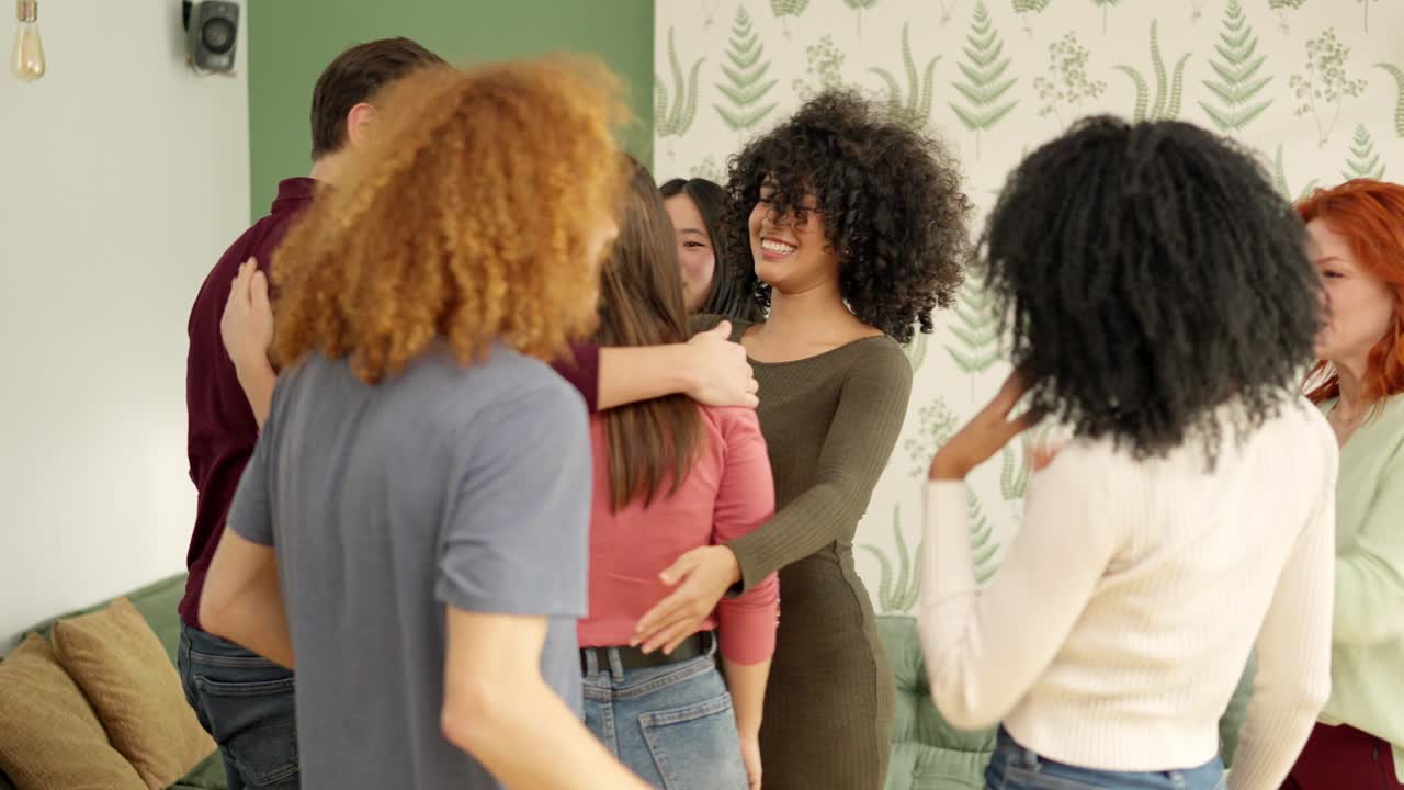 Meeting of diverse friends embracing together at home
