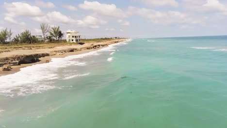 Jensen-Hutchinson-Island-coast-line-turquoise-water-alone-the-shoreline,-drone-view