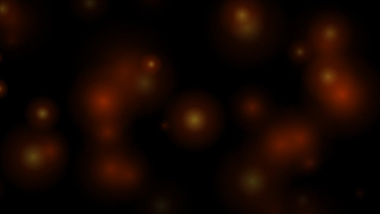 Abstract Background of Glowing Orange Bokeh Particles on Black