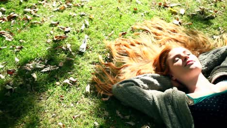 Beautiful-redhead-napping-on-lawn