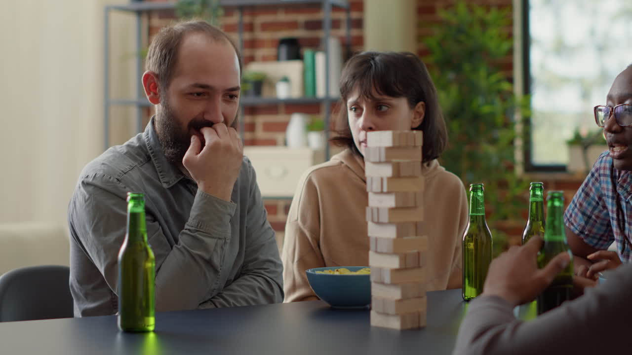 Positive people having fun with society game in living room