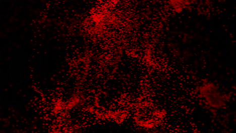 explosión de partículas rojas sobre fondo negro