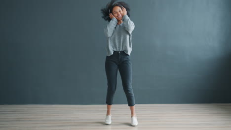 happy woman dancing with headphones