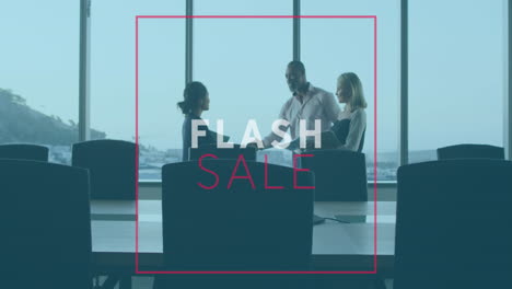 animation of flash sale text banner over diverse businesspeople discussing shaking hands at office