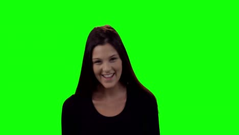 smiling beautiful woman standing against green screen