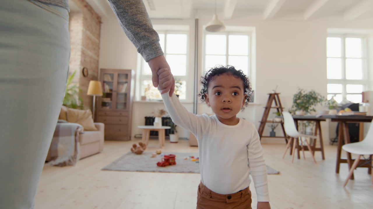Cute Toddler Walking with Mother in Living Room