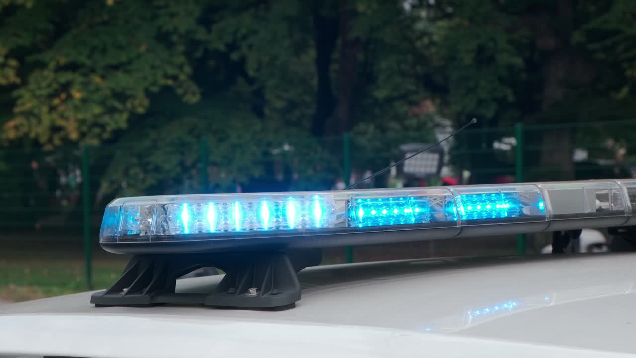 Blue flash light on police car, emergency and security concept, close up