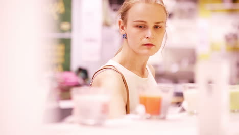 young woman smelling scented candles