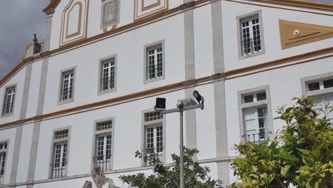 white convent facade with ornate trim in portimão portugal under cloudy sky