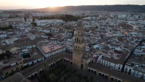 circling aerial view of tower of mosque-cathedral during dusk in cordoba, spain