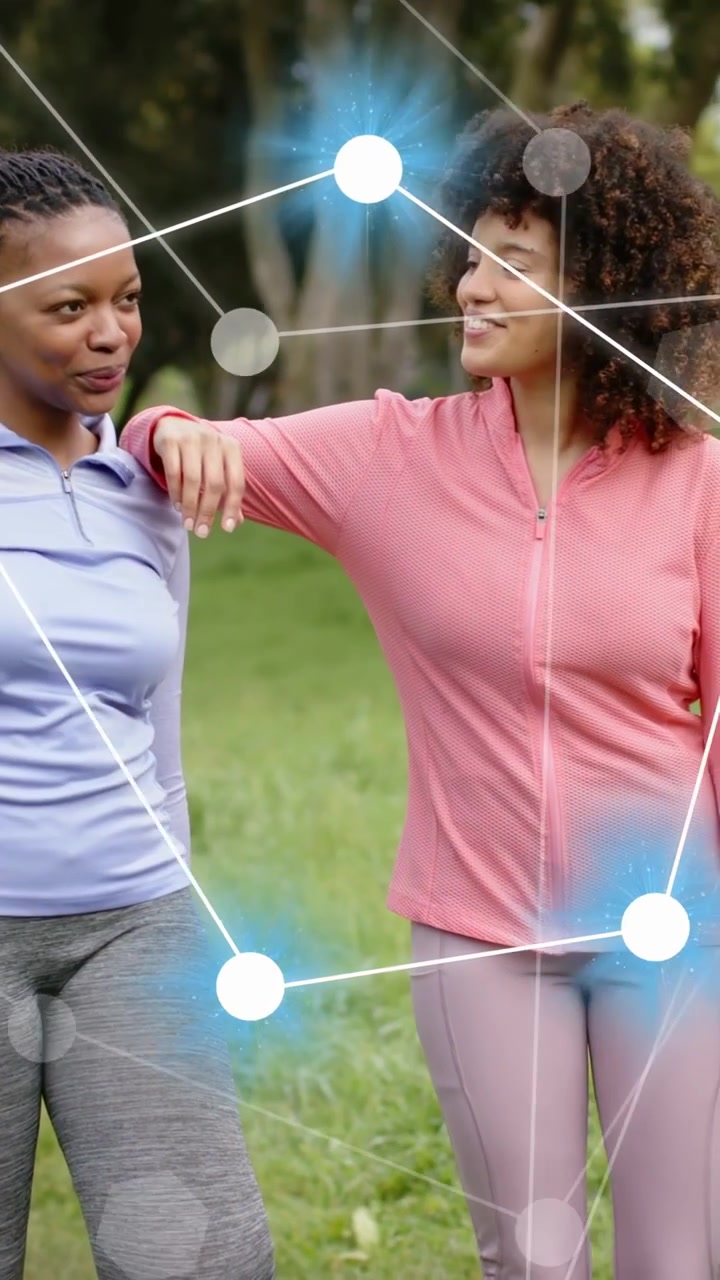 Vertical video: Two women placing arm on shoulder in park, sparking node overlay showing tech links
