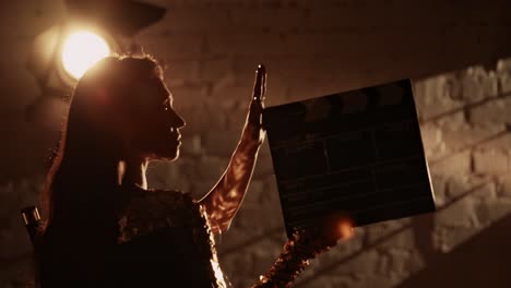 woman holding clapperboard on a film set