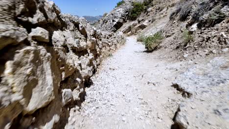 A-narrow-path-winds-between-rocky-walls-in-Sudak,-Crimea,-Russia