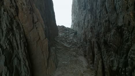 torghatten in norway person walking inside the hole