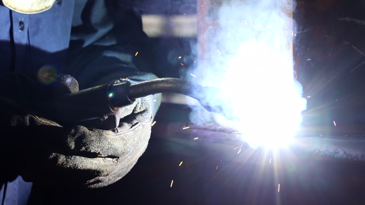 Close up of a welder's hands on slow motion