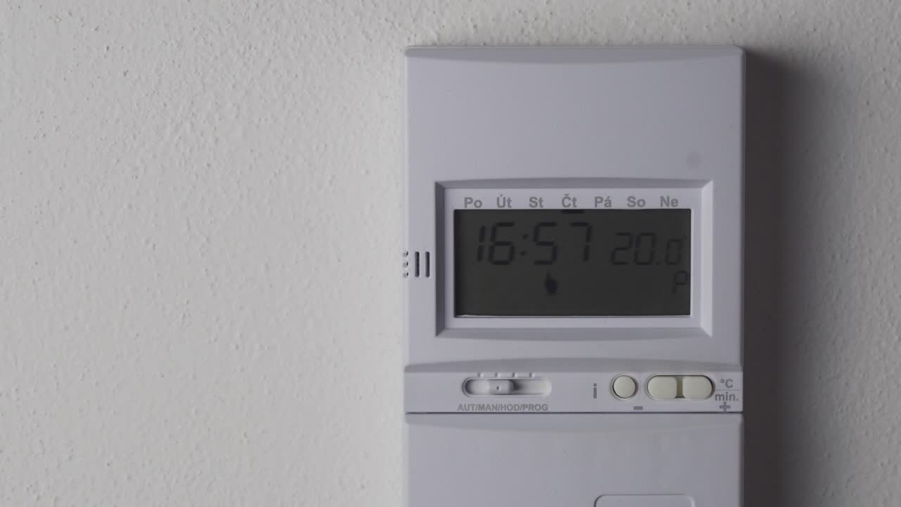 ajuste de la temperatura del termostato de calefacción más alta, pantalla digital y vista de primer plano con la mano