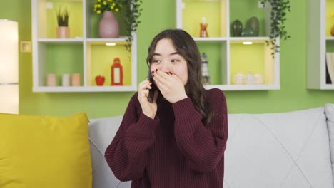 young asian woman gets happy news.