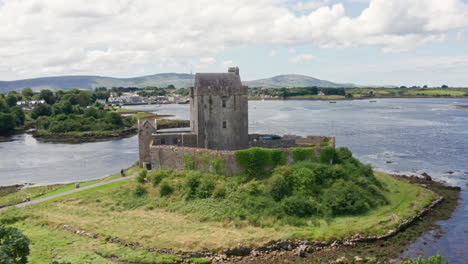 Aerial-Reverse-Shot-of-Dunguaire-Castle-in-County-Galway,-Ireland