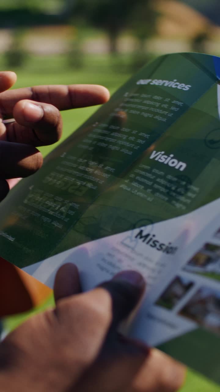 Person Reading a Real Estate Brochure