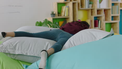 happy caucasian woman student jumping on colorful pillows relaxing female resting enjoying lunch break in trendy office workplace