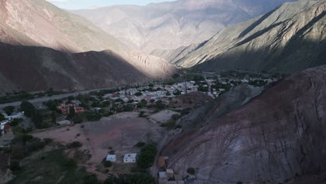 aerial drone fly above valley of purmamarca, hills of seven colors, town, quebrada de humahuaca, valley city at unique south american travel landscape