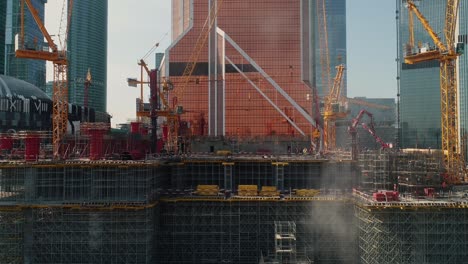 grúas y andamios en el sitio de construcción de edificios de gran altura