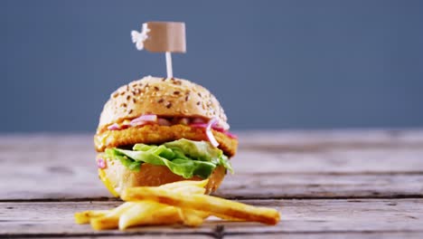 Hamburger-and-french-fries-on-wooden-table