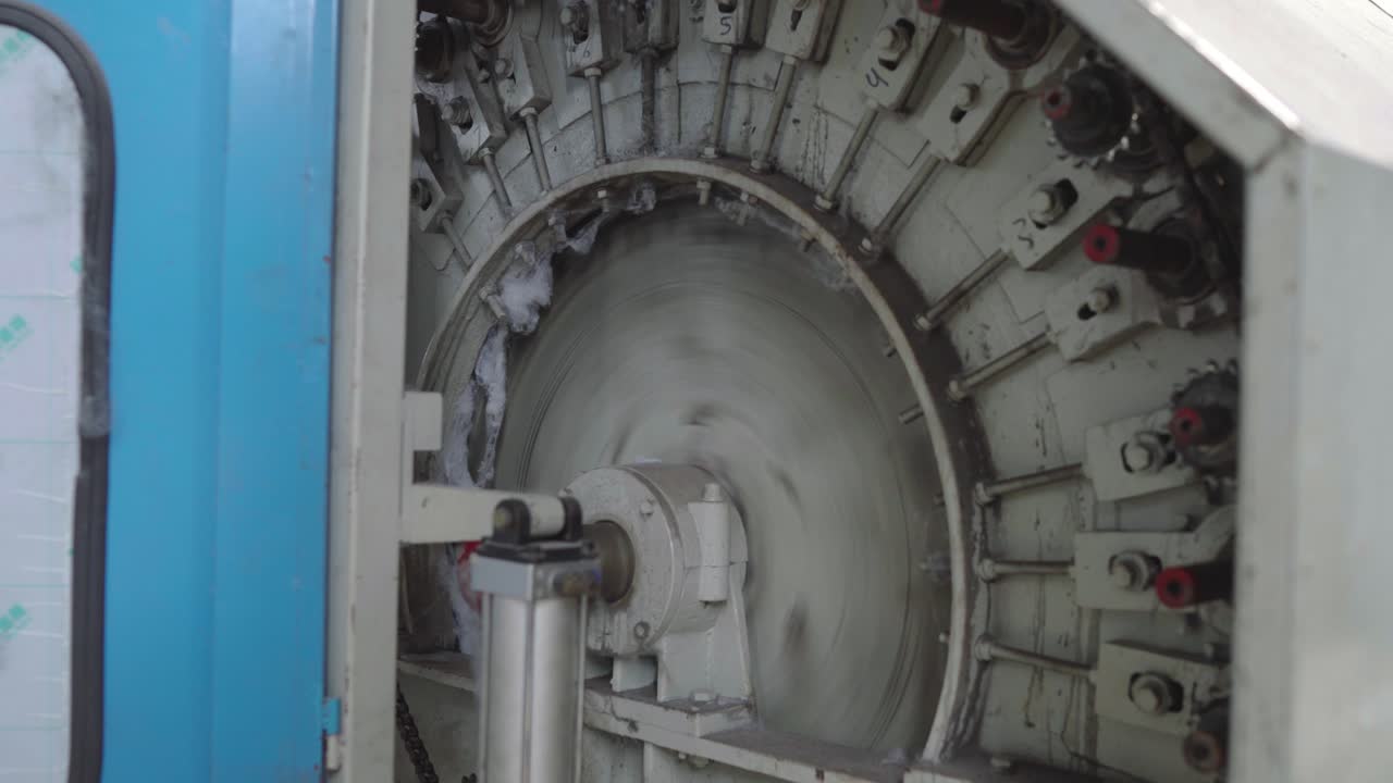 Knitting machine at textile factory, Closeup