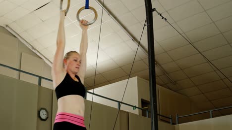 gymnast practicing with ring row