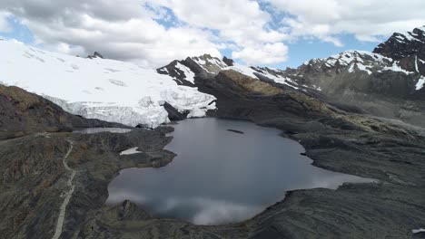 a pristine glacial lake reflects the towering andes with snow-covered peaks