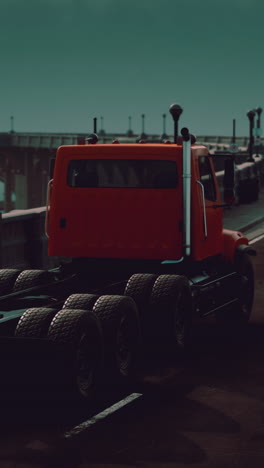 red semi-truck on a city bridge