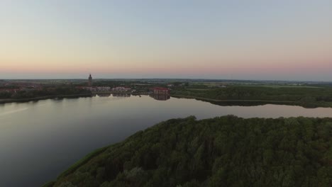 aerial: the pier, beach and lighthouse during sunset near the village westkapelle, the netherlands