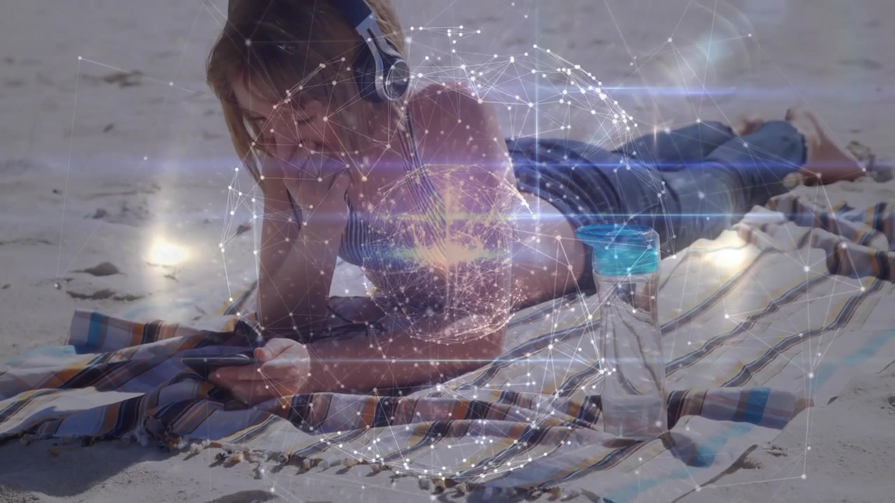 On start girl on beach picking up phone and scrolling as network forming rotating globe technology