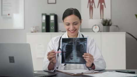 Happy-Indian-female-doctor-checking-X-ray-test