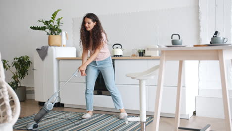 woman cleaning and dancing in the kitchen