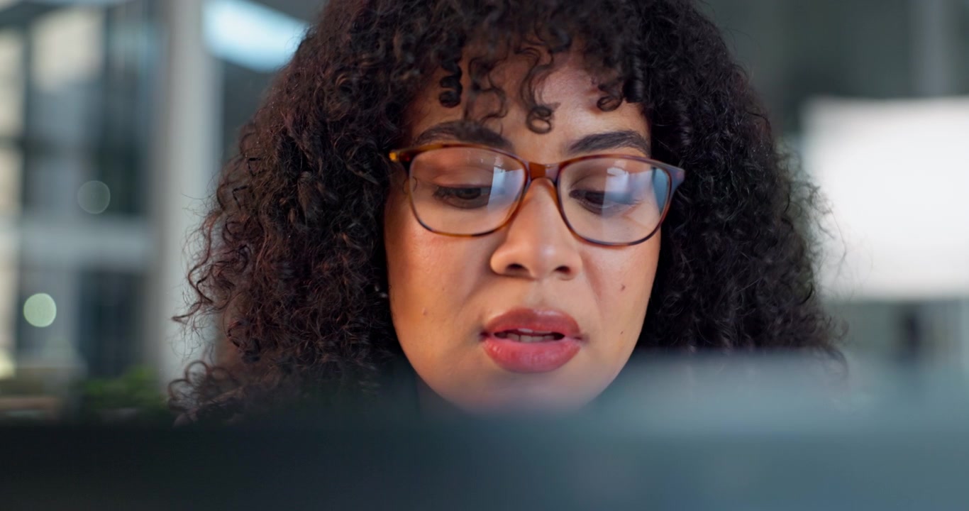 Focused Woman Working on Computer in Office