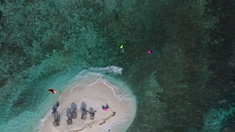 aerial view of tropical island with windsurfing activities