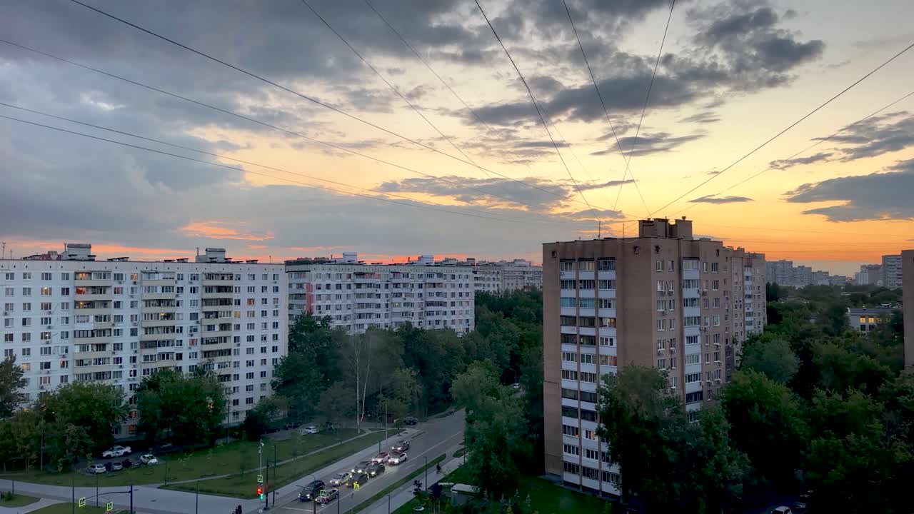 Beautiful summer sunset over multi-storey buildings in the city