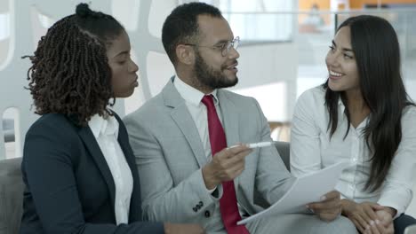 cheerful business colleagues discussing project