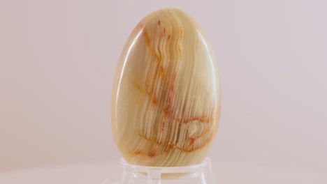 small onyx mineral egg slowly rotating on a turn table