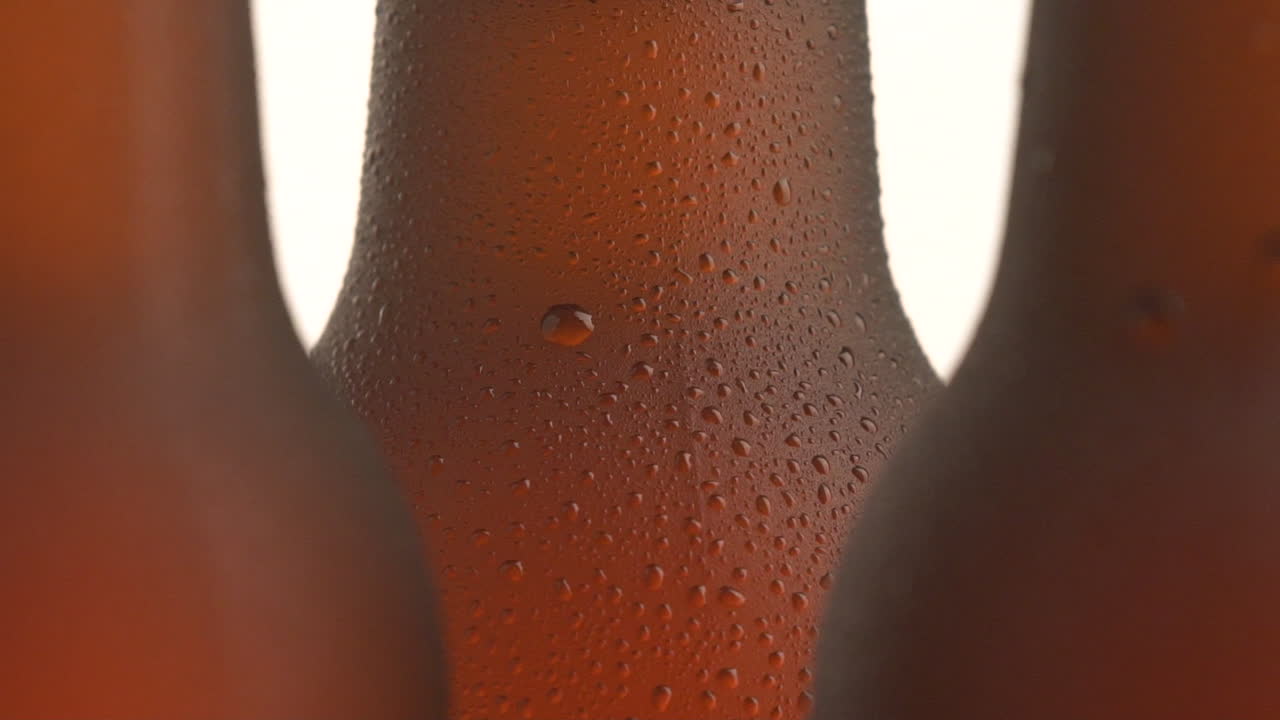 Three beer bottle rotating on white background