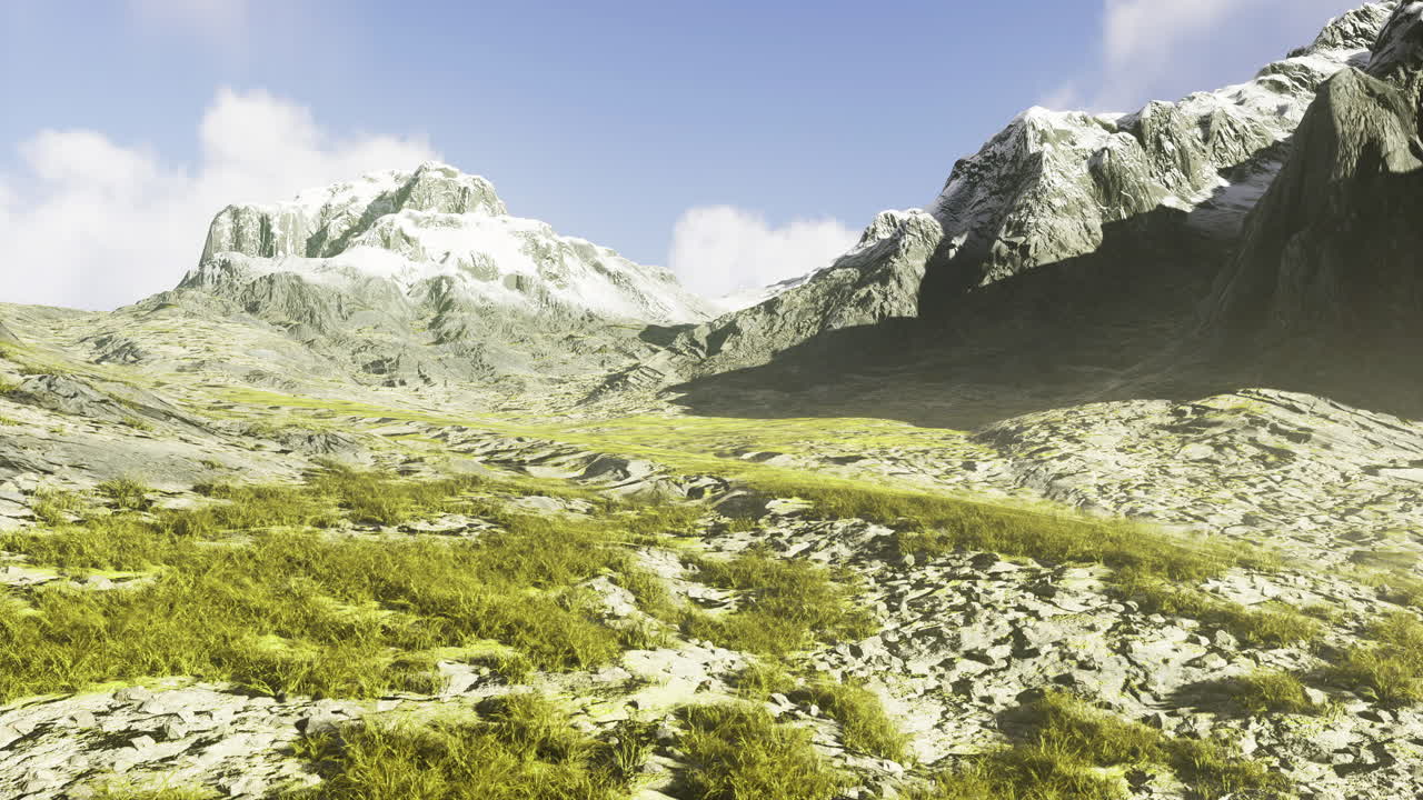 Rocky mountain landscape with greenery under a bright blue sky