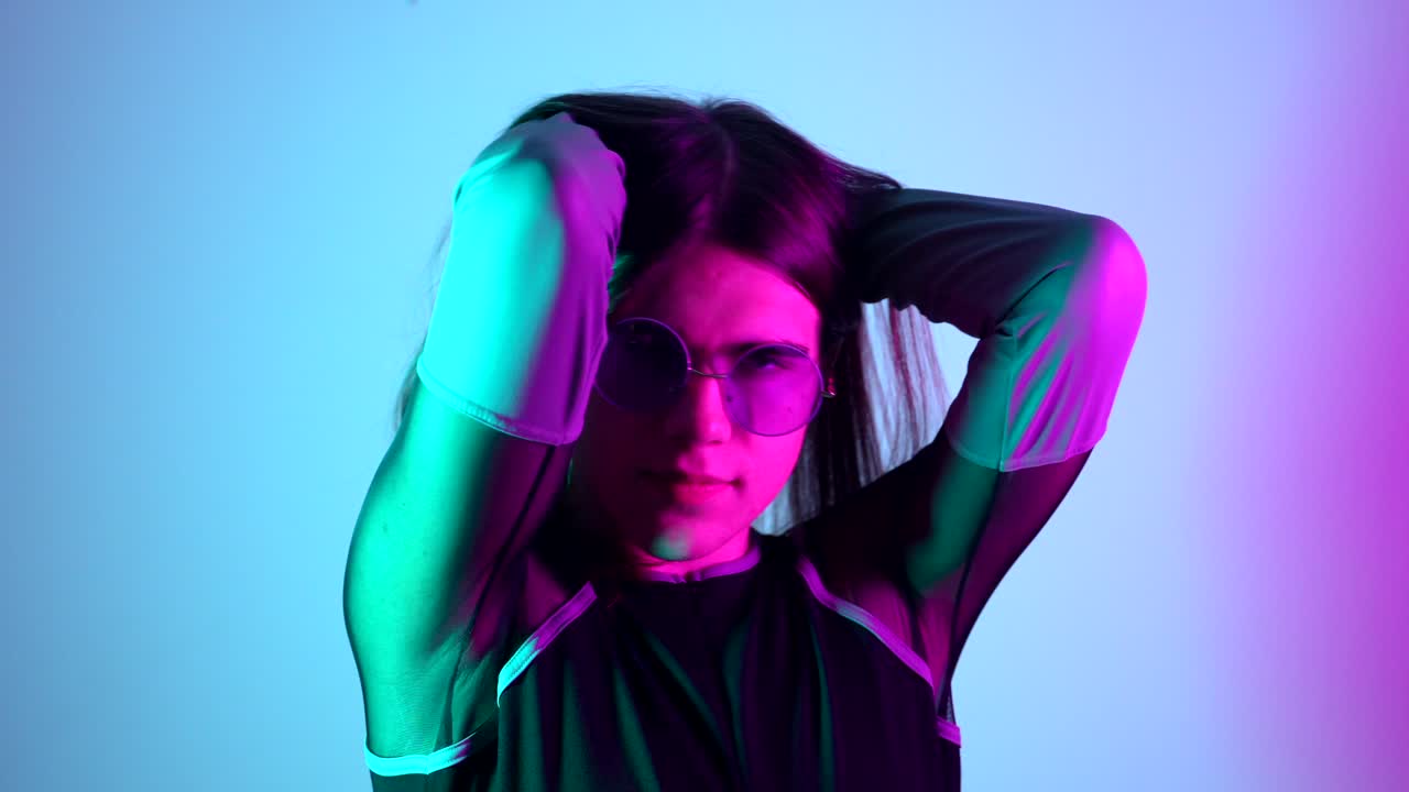 Portrait of a woman with sunglasses in neon lighting