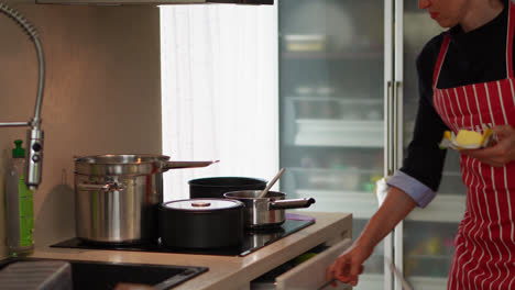 portrait of a woman opening butter in the kitchen for cooking