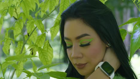 epic facial close up of a latin young woman with leaves of a tree in the background